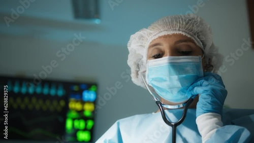 Female Doctor auscultates to the patient's heart with stethoscope