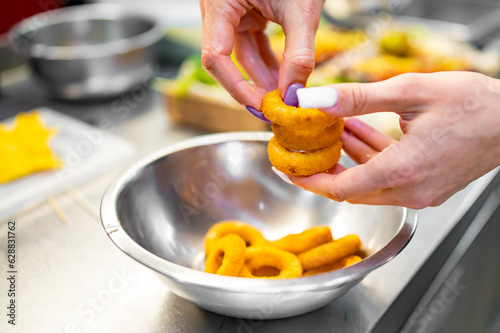 woman hand hold Onion rings on kitchen