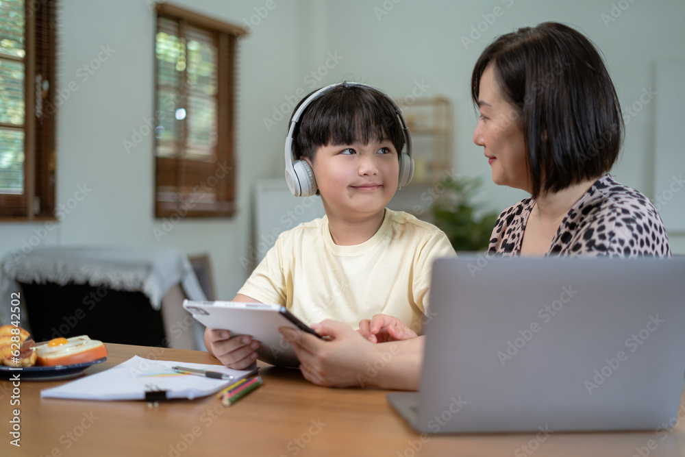 Parents helping children with homework at table at home. Parents helping children with homework at table at home.