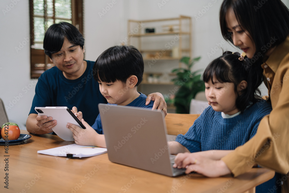 work from home education concept and family at home sitting at desk business woman working on internet in laptop child writing in notebook work from home education concept and family at home sitting at desk business woman working on internet in laptop child writing in notebook