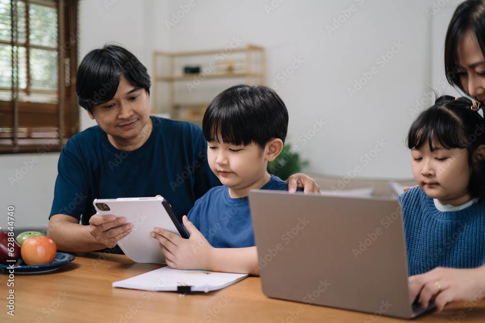 work from home education concept and family at home sitting at desk business woman working on internet in laptop child writing in notebook work from home education concept and family at home sitting at desk business woman working on internet in laptop child writing in notebook
