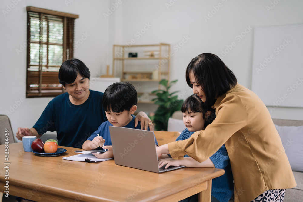 work from home education concept and family at home sitting at desk business woman working on internet in laptop child writing in notebook work from home education concept and family at home sitting at desk business woman working on internet in laptop child writing in notebook