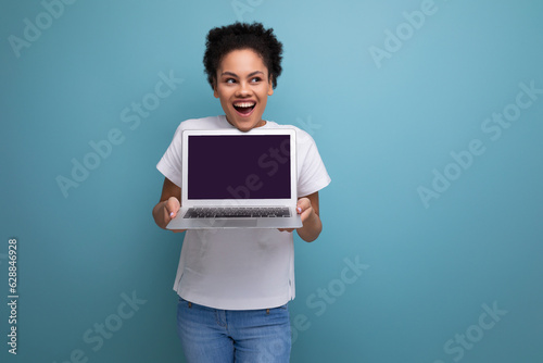 young latin brunette student woman in white t-shirt ready to present her project using laptop with mockup