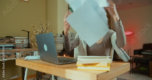 Angry and frustrated freelance business woman drop documents at home office