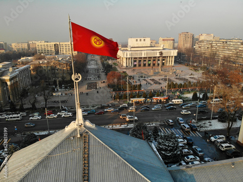 Kyrgyzstan flag near theatre in Bishkek at winter time. High quality photo photo