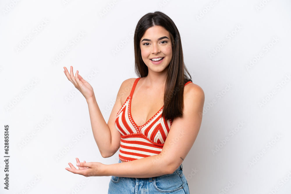 Young Brazilian woman isolated on white background extending hands to the side for inviting to come Young Brazilian woman isolated on white background extending hands to the side for inviting to come