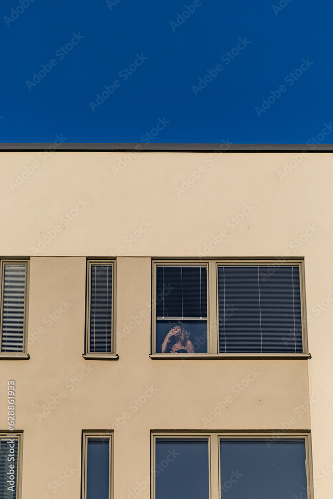 Stockholm, Sweden A women blows a kiss from a residential window.