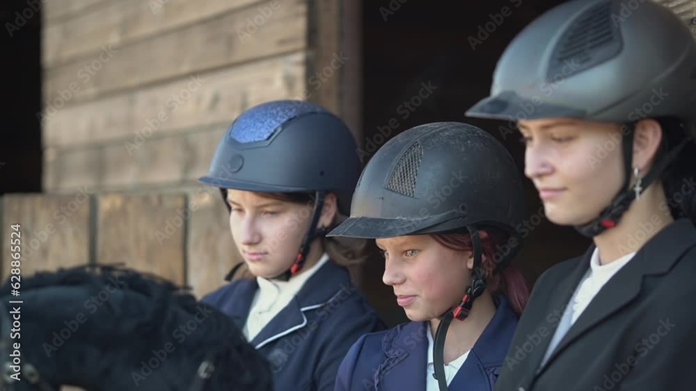 three teenage girls. teenagers in equipment for equestrian sports.teenagers jump over obstacles. Horseback riding. equestrian sport.Full HD video recording three teenage girls. teenagers in equipment for equestrian sports.teenagers jump over obstacles. Horseback riding. equestrian sport.Full HD video recording