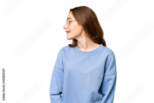 Teenager girl over isolated chroma key background laughing in lateral position © luismolinero