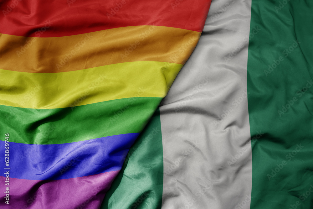 big waving realistic national colorful flag of nigeria and rainbow gay pride flag .
