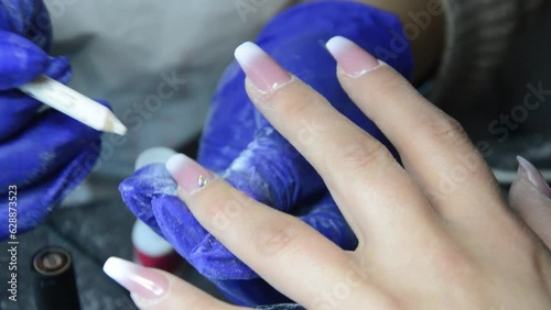 Woman in a nail salon receiving a manicure