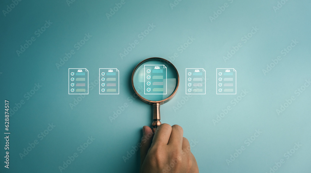 Businessman showing virtual icon of human resources or HRM, magnifying glass focus on recruitment icon. Recruit employees for leadership services, leading organizations and prospecting. Businessman showing virtual icon of human resources or HRM, magnifying glass focus on recruitment icon. Recruit employees for leadership services, leading organizations and prospecting.