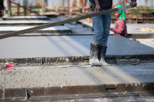 Asian man worker pouring concrete slab. Asian Engineer man working at precast factory. Engineering worker in safety hardhat at factory industrial facilities. Heavy Industry Manufacturing Factory