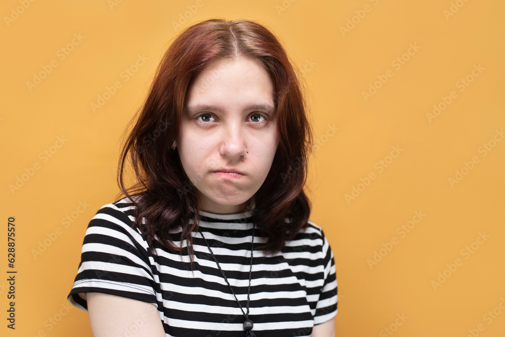 Teenage girl toothache, girl has a swollen cheek, she feels severe pain from a tooth and is suffering, tears appear in her eyes, medical dental concept