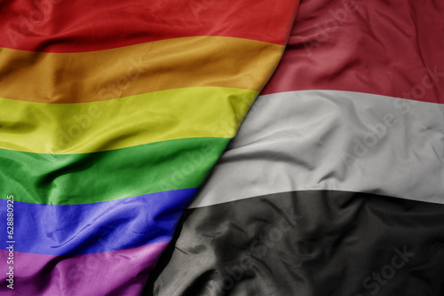 big waving realistic national colorful flag of yemen and rainbow gay pride flag .