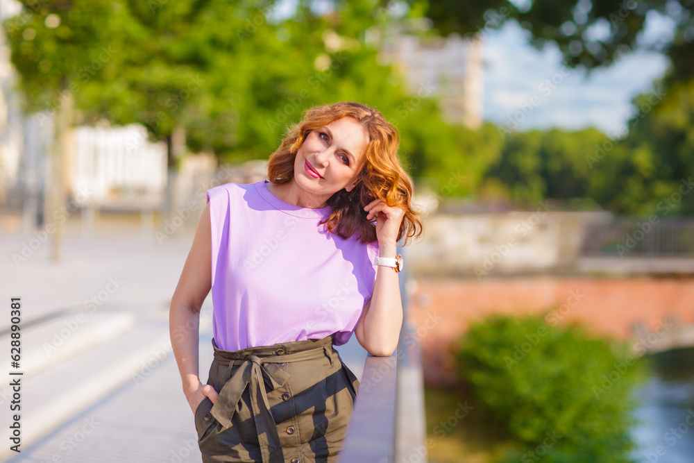 Beautiful successful middle aged woman posing on the street photo shoot Beautiful successful middle aged woman posing on the street photo shoot