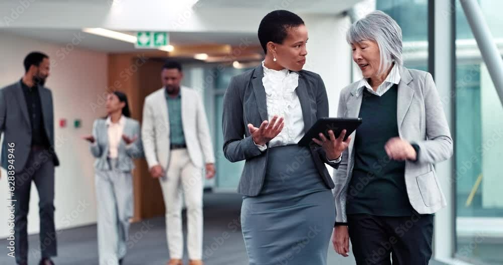 Business women, walking and talking with tablet, planning and corporate project in office. Teamwork, collaboration and friends or professional people with tech for discussion, chat or proposal advice