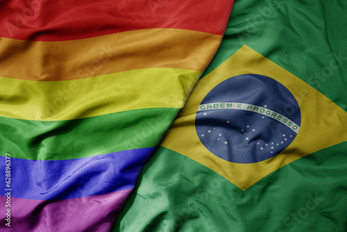 big waving realistic national colorful flag of brazil and rainbow gay pride flag .