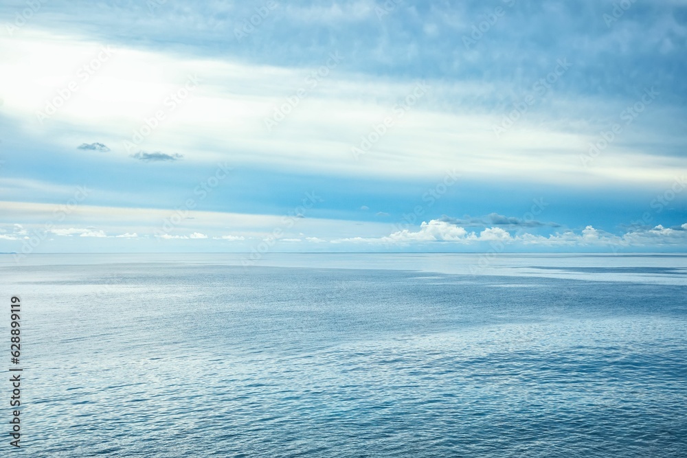 Cloudy blue sky over the blue sea in summer