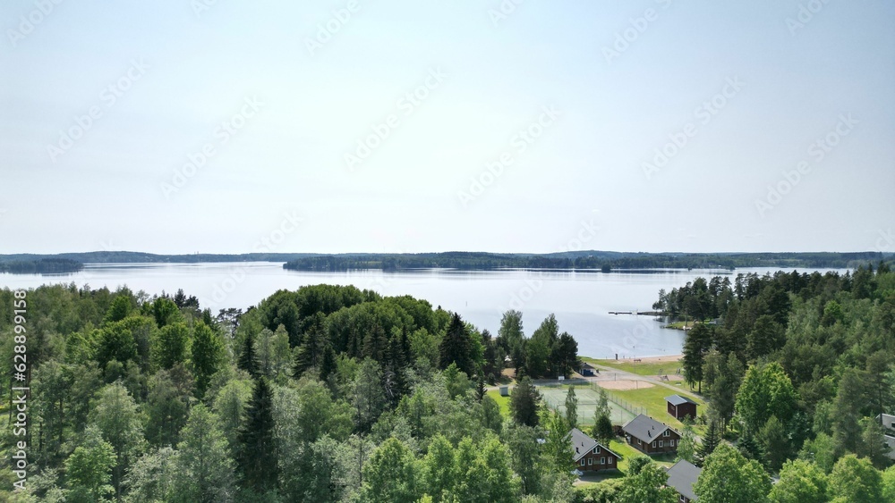 Aerial view of a tranquil lake surrounded by residential properties nestled in a sprawling landscape