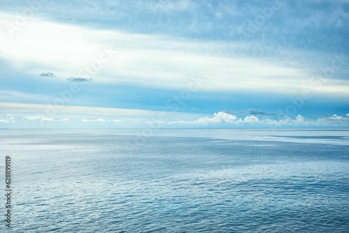 Cloudy blue sky over the blue sea in summer