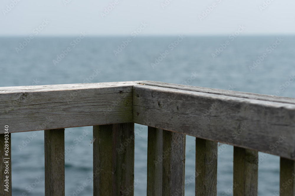 wooden fence around deck with view of the lake (focus on wood structure) wooden fence around deck with view of the lake (focus on wood structure)