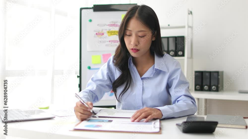 Businesswoman reading documents while working on accounting paperwork and analyzing financial budgets in the office. Businesswoman reading documents while working on accounting paperwork and analyzing financial budgets in the office.
