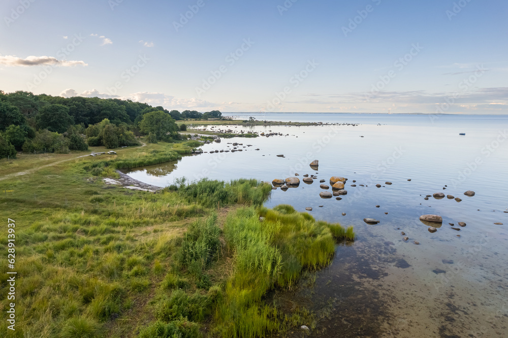 Aerial view of a beautiful maritime landscape with wild nature, many stones trees and grass. Little island with wild nature. Wild beach, pasture. 