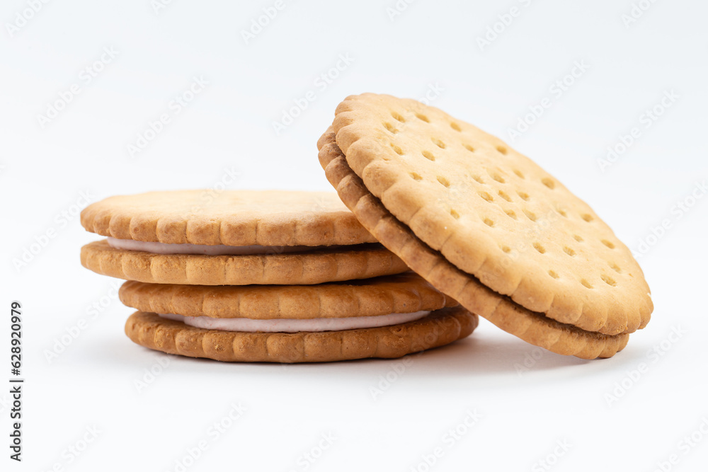 Stacked sandwich biscuits with pink cream filling. Sandwich cookies lie one on top of the other Stacked sandwich biscuits with pink cream filling. Sandwich cookies lie one on top of the other