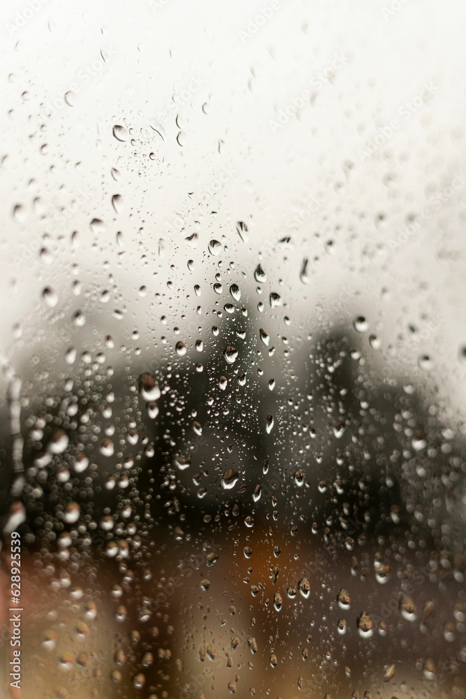 Closeup of a window covered in raindrops