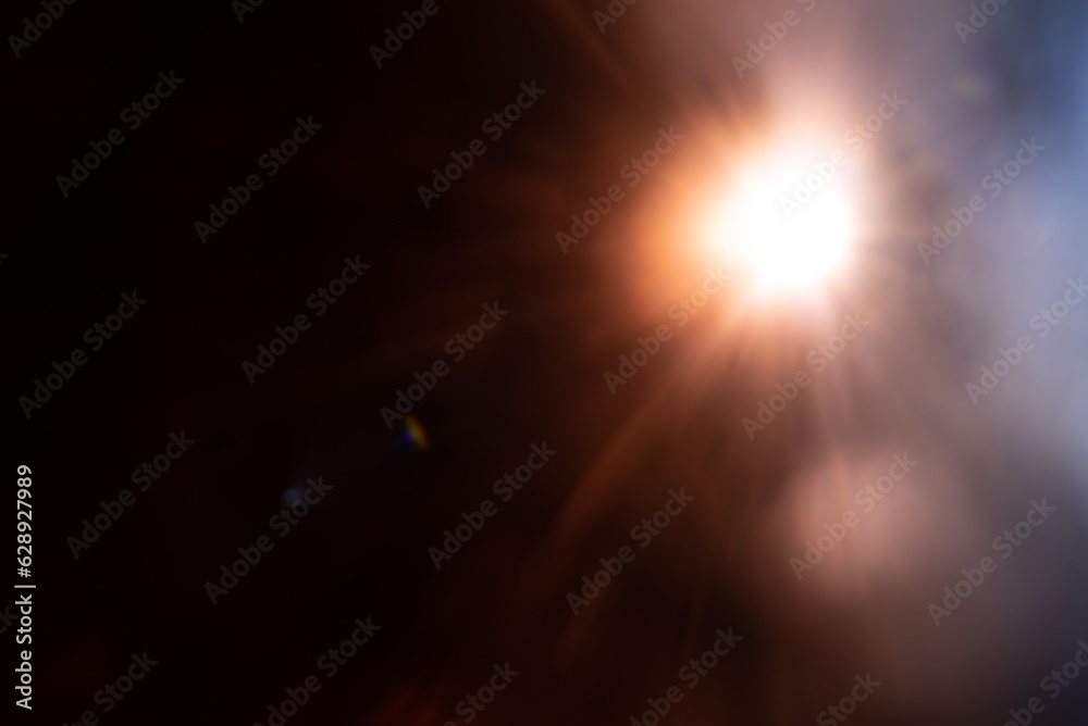 Blurred image Sun flare on the black background