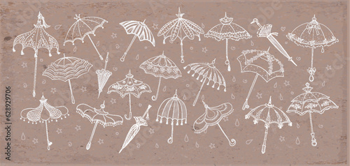 Collection of doodle vintage umbrellas on brown parcel paper background. Vector sketch illustration.
