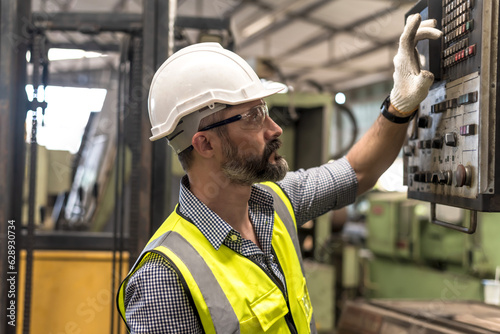 Portrait Caucasian Engineer man working in industrial factory photo