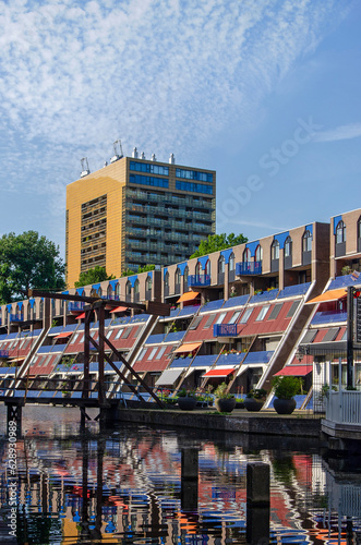 Rotterdam, The Netherlands, July 26, 2023: modern buildings and a classic drawbridge reflect in the water of Delftsevaart canal photo