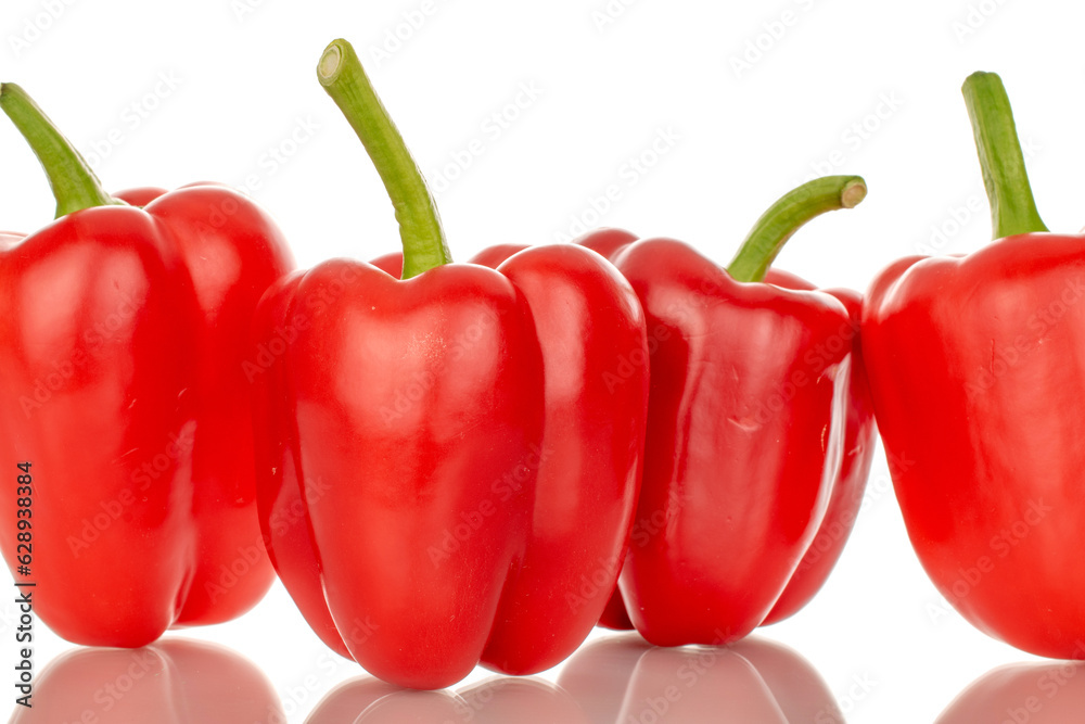 Several red bell peppers on slate stone, macro, isolated on white background. Several red bell peppers on slate stone, macro, isolated on white background.
