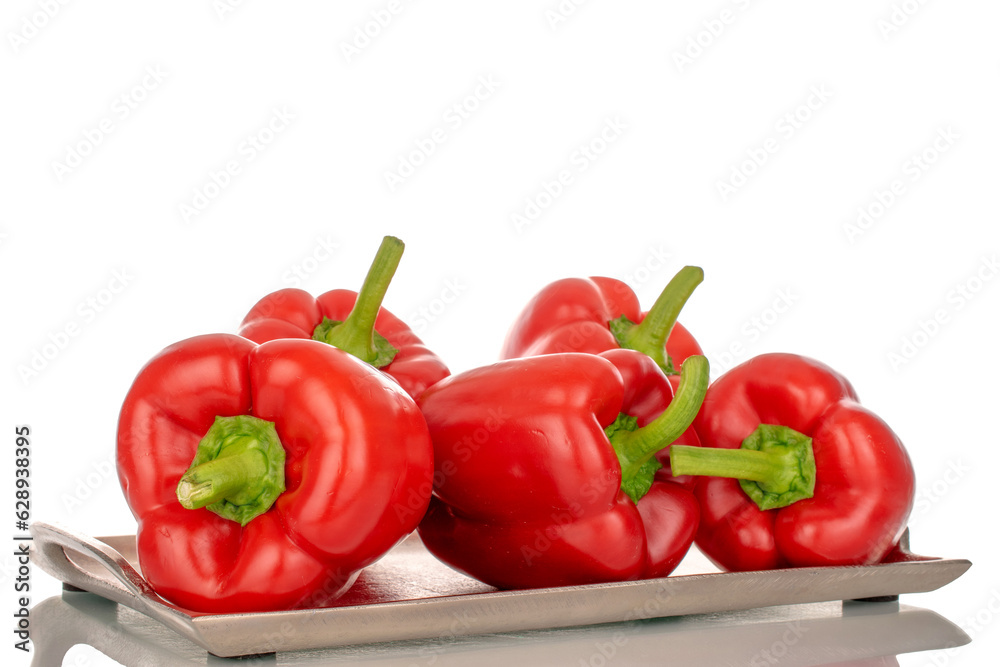 Several red bell peppers with metal tray, macro, isolated on white background.
