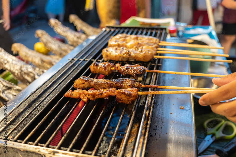 BBQ Sauced crocodile and duck meat in skewers from Asian cuisine. Usually in street markets. shish kebab and crocodile grilled on street in thailand