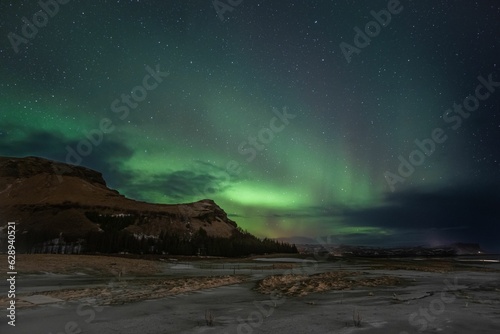 aurora borealis in the night sky above Reykjavik, Iceland, with stars twinkling in the background