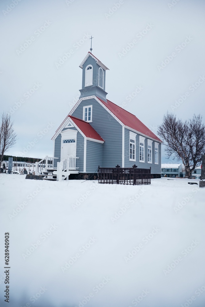 winter scene featuring a traditional church with a red roof and white windows in Reykjavik, Iceland