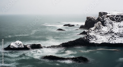 winter landscape in Reykjavik, Iceland featuring a lake and a rocky outcropping on the shore