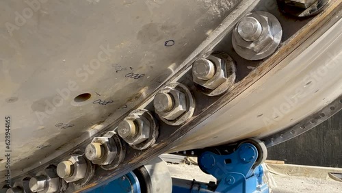 Bolted connection of parts of a ball mill close up. Copper processing plant equipment