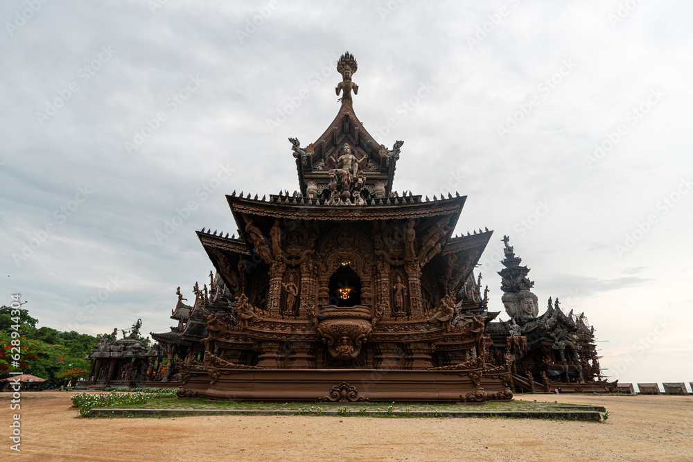 Sanctuary of Truth, Pattaya, Thailand, wooden temple by the ocean during sunset on beach of Pattaya. Temple of Truth in Thailand. Beautiful wooden building design. Sanctuary of Truth, Pattaya, Thailand, wooden temple by the ocean during sunset on beach of Pattaya. Temple of Truth in Thailand. Beautiful wooden building design.