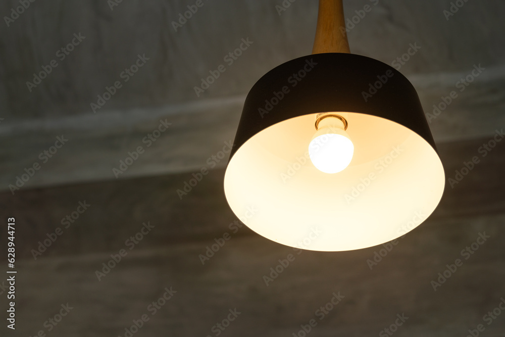 Classic round ceiling lighting lamp is glowing in the dark room. Interior decoration object, close-up and selective focus. Classic round ceiling lighting lamp is glowing in the dark room. Interior decoration object, close-up and selective focus.
