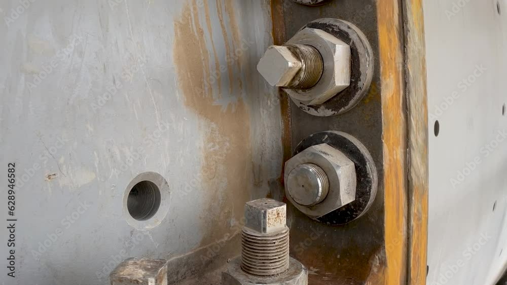 Bolted connection of parts of a ball mill close up. Copper processing plant equipment Bolted connection of parts of a ball mill close up. Copper processing plant equipment