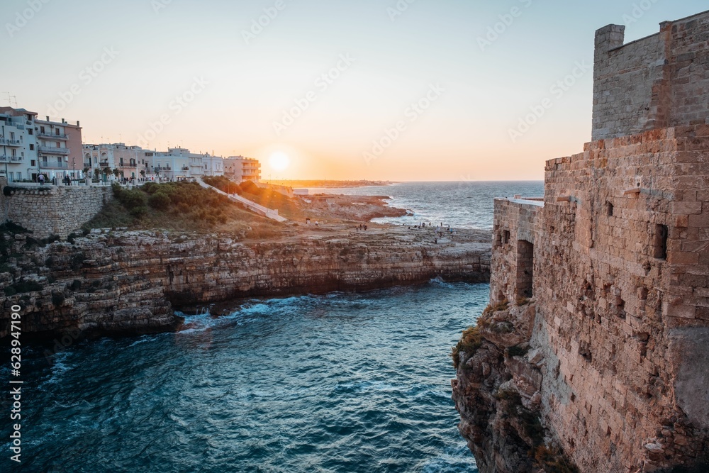 Picturesque landscape of a coastal cliff face and buildings Polignano a Mare, Puglia, Italy