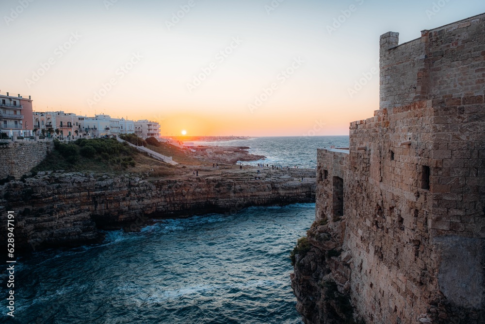 Picturesque landscape of a coastal cliff face and buildings Polignano a Mare, Puglia, Italy Picturesque landscape of a coastal cliff face and buildings Polignano a Mare, Puglia, Italy