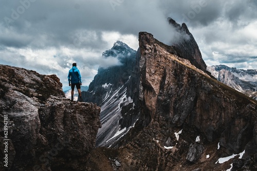 Daring climber conquering the jagged mountainous heights of the Dolomites, part of the Alps in Italy