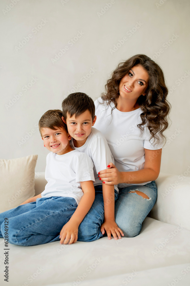 Mother sitting with sons on sofa