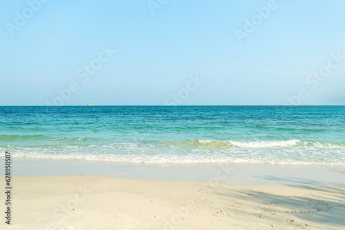 Turquoise sea water with white sand beach and blue sky. Horizon line
