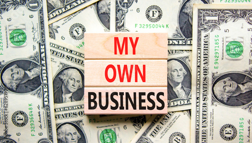 My own business symbol. Concept words My own business on wooden block. Dollar bills. Beautiful background from dollar bills. Business motivational my own business concept. Copy space.